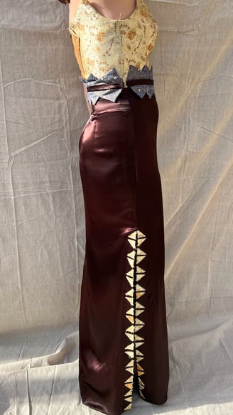 A woman in a gold brocade and satin evening gown