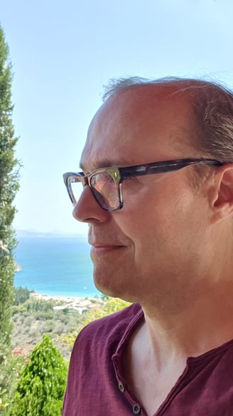 a man in a red shirt and glasses