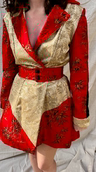 The front of red cotton, black lace, and gold butterfly coat