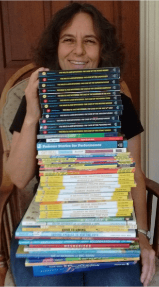 Holding tall stack of my books