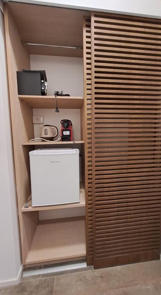 a small refrigerator with a microwave and a microwave