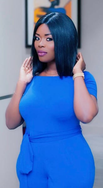 Delay in a blue overall dress.