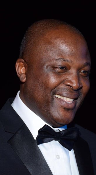 Ibrahim Mahama in a black tuxedo smiling.