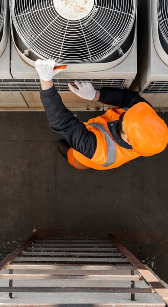 a man in a safety vest is standing on a ladder