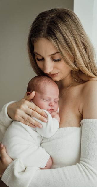 a woman holding a baby in her arms
