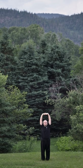 Forest landscape with man stretching