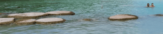two people are swimming in a body of water