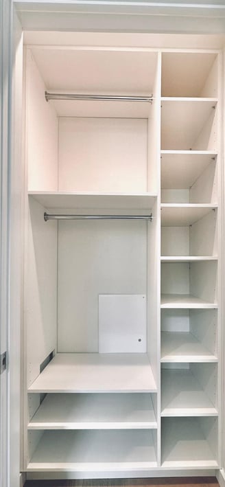 a closet with a laptop computer and a laptop