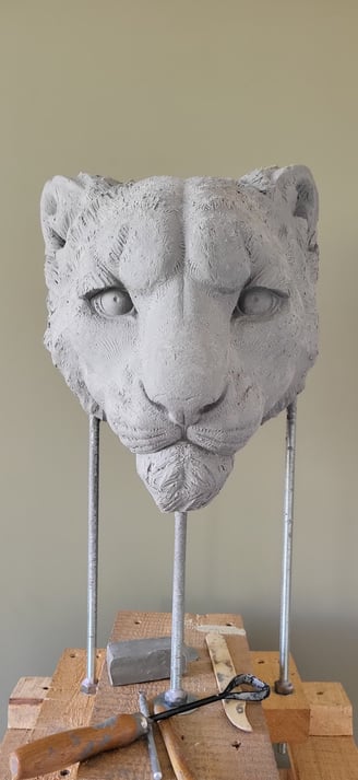 Clay snow leopard head.