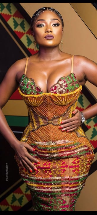 Efya Nocturnal in an African print dress.
