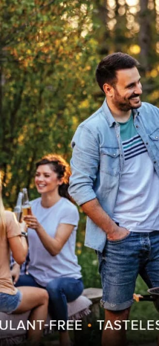 a man and woman standing in front of a grill