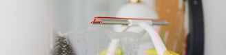 wiping mirror during home cleaning service