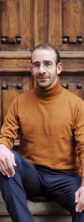 Leonardo Rizzo portrait, sitting on a step up to a door