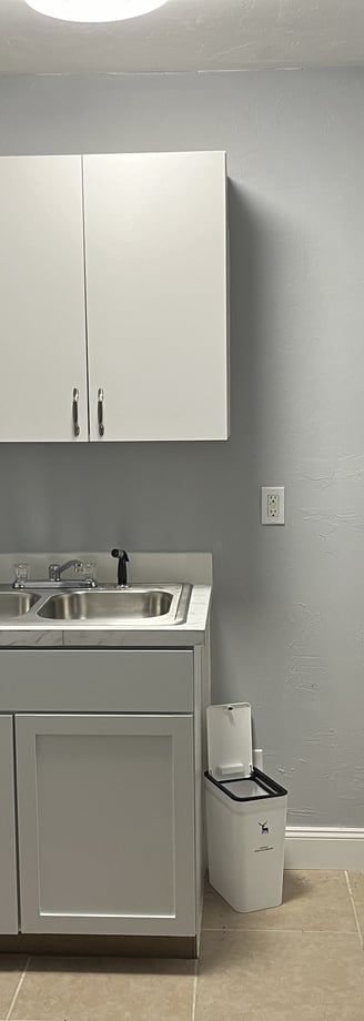 a kitchen with a sink, microwave, and refrigerator