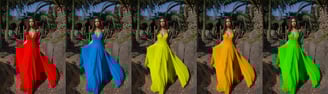 a woman in a colorful dress standing in front of a tree