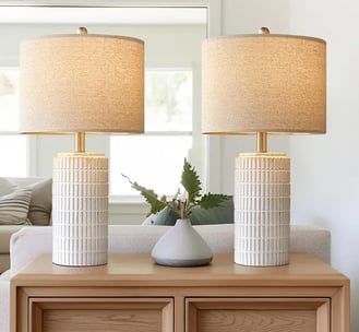a pair of lamps with a white ceramic table lamp