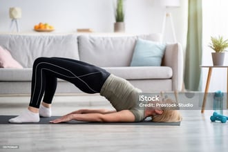 a woman doing a yoga pose on a yoga mat