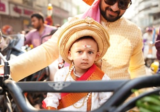 boy kid in maharastrian traditional outfit riding a motorbike in girgaon gudipadwa shobhayatra 2025