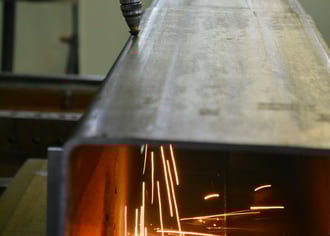 automation robot plasma cutting through a metal beam