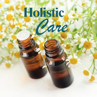 2 bottles of essential oils and "Holistic Care" written to advertise menopause coaching