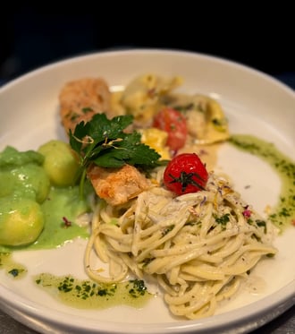 a plate of pasta with shrimp and vegetables