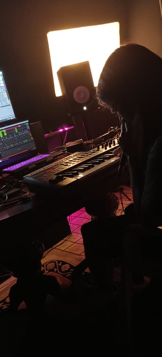 A memeber of Kalokoro Teke singing and composing in their home music studyg