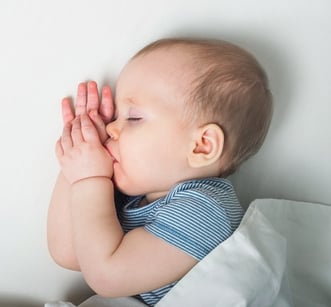 a baby sleeps soundly in its cradle