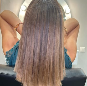a woman with long hair and a balayage natural 