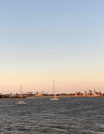 Boats anchored in Carnarvon Bay at sunset, Western Australia.