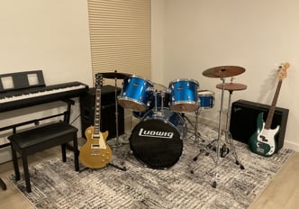 a room with a piano, guitar, and a piano