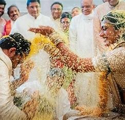 a man and woman in white wedding attire and a man in a white suit