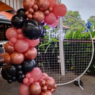 Rose gold, rose wood and black balloons prepared for Violet's balloon garland in Redlands.