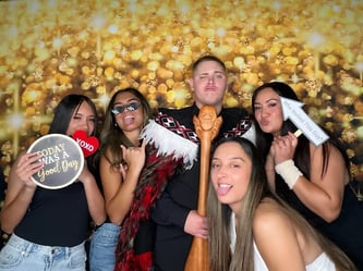 Guests in the golden sparkle photo booth for Kaea's 21st celebration in Redlands.