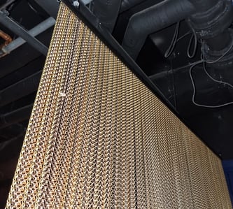Gold shades of hanging chains to divide the chill out room at Penny's 40th at the Vault in Brisbane.