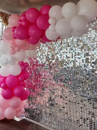 Silver shimmer wall with pink and white garland for Taijana's 21st birthday in Redlands.