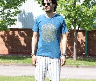 a man standing on a skateboard in the grass