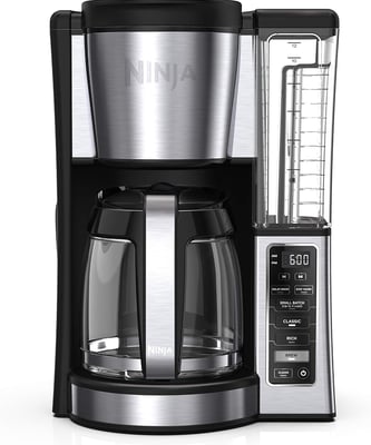 A sleek smart coffee maker brewing rich black coffee, ideal for a hassle-free morning routine.