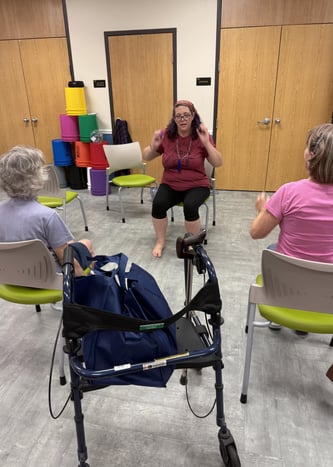 Rachel teaching gentle chair yoga class at Micco library