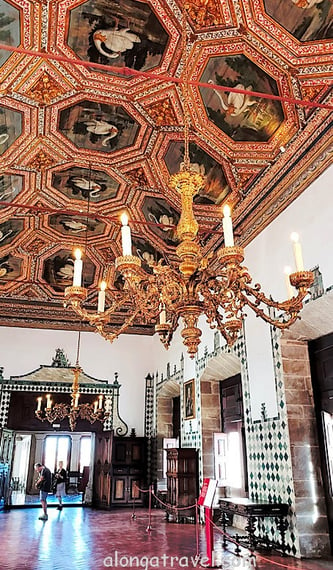 a ceiling made a many similar panels with swans in Swan Room in Sintra Palace