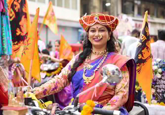 woman in maharastrian traditional outfit riding a motorbike in girgaon gudipadwa shobhayatra 2025