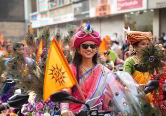 woman in maharastrian traditional outfit riding a motorbike in girgaon gudipadwa shobhayatra 2025