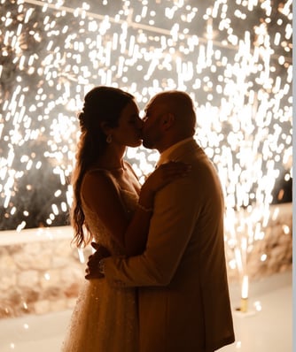 Magical stage fountain fireworks lighting up a Santorini wedding under the stars.