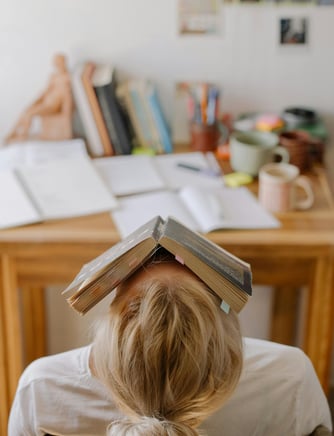 a woman with a book on her head and a book on her head