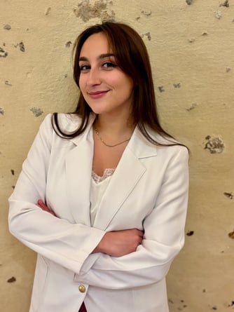 a woman in a white jacket and red skirt