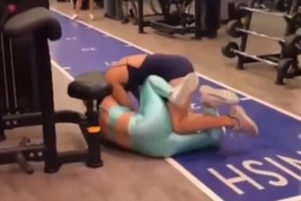 a woman is doing a backflip in a gym
