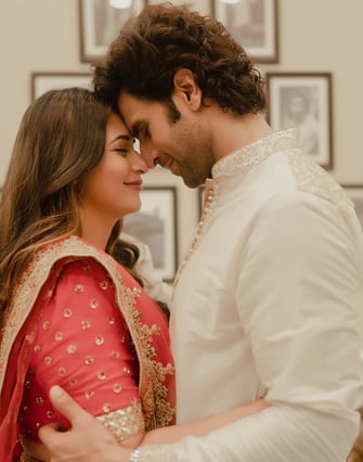 a man and woman in a white and red outfit