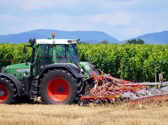 a tractor with a plow on a field