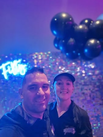 Carly and Kahn having a selfie in front of the finished iridescent shimmer wall in Alex Hills.