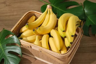 a basket of bananas and a banana peeler