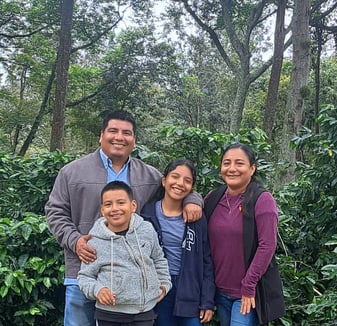 a family posing for a photo in a park